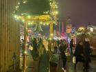 People ring a bell at Christmas markets to bring in luck for the upcoming year