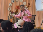 A woman playing the traditional horse headed fiddle