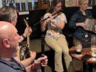 This is a group of people playing trad music. You can see a couple flutes as well as a banjo and an accordion