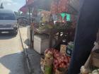 A street vendor selling produce and snacks at the taxi rank in Maseru District 