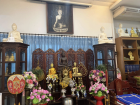 The main altar inside a Buddhist temple, where visitors offer flowers and prayers as part of their daily spiritual practice