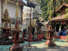 Temple courtyards filled with statues and greenery, highlighting how nature is intentionally integrated into Buddhist spaces to support mindfulness and calm