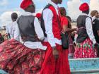 The men were wearing traditional dress including red berets on their heads