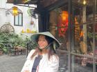 This is me at a coffee shop! I am wearing a traditional Vietnamese hat