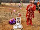 My baby cousin, Noah, performing cúng at his grandmother’s burial site