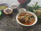 A bowl of bún riêu cua from my rural community with crab, noodles, tomatoes and fresh herbs
