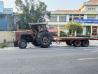A farmer drives a tractor in my rural community where farming is a main job
