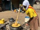 Meriam helping cook dinner, she is making jollof