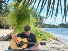 Playing my guitar on a beach closeby 