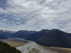 A river valley with a set of crossing streams set against the backdrop of mounts in Arthur's Pass National Park