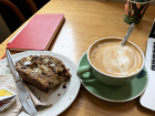 An apple raisin scone and a Flat White. Both scones and flat whites (espresso with milk) are very popular Kiwi coffee shop items