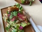 Delicious smørrebrød with salmon, pickled onion, micro greens, a mustard-mayo dressing