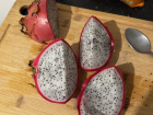 Dragon fruit cut up into quarters, you can use a spoon to scoop out the flesh