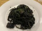 This pasta dish's name translates to "pasta with black of squid," which means that the sauce was made with squid ink! I had this pasta in Venice and it was very good, albeit a little salty from the seafood!