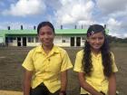 Geraldine and Britney in front of their classroom