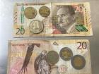Peruvian S/20 bills with coins