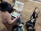 A lady doing a cool painting on a random sidewalk