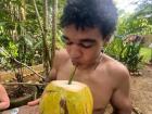 Drinking coconut water, fresh from a coconut tree!