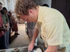 Thinning the masa for tortillas; the masa is made out of ground corn