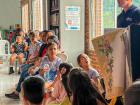 Adults and children gather to hear my introduction to the English classes I offer in my community for free