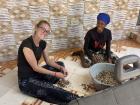My host sister and I shelling groundnuts 