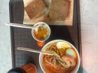 A Singapore breakfast of kaya toast, soft-boiled eggs and kopi, with laksa.