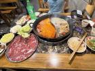 This is hotpot. You cook your meats and vegetables in a pot of flavorful broth with your friends!