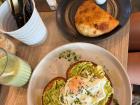 This is food from one of our favorite cafes. On the table is avocado toast and an empanada