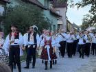 Local community wearing folk outfits at a wine festival