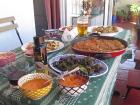 A table set for a friendly feast: empanada, boiled potates, grilled peppers, fresh avocado and tomato, salmorejo, bliss.