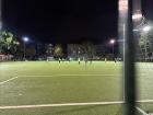 Kids playing soccer at night near my apartment