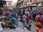 The bustle of an early morning market in Kathmandu as people prepare for the festival