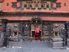 A woman makes an offering in the early morning at Bhaktapur Durbar Square