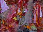 Flowers, tika and other offerings adorn figures in a temple on the outskirts of Kathmandu