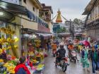 A busy street in Kathmandu under the Boudha Stupa