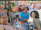 My teachers and I at a cookout playing a game of Dominoes