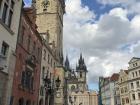 Walking through Old Town Square with the Old Town Hall and Church of Our Lady before Týn in view