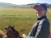 Horseback riding through a Mongolian valley