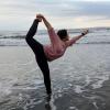 Trying yoga poses on the beach in Kamakura, Japan