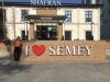 A picture of me next to an "I heart Semey" sign!