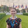 Standing in front of international flags at the UNESCO headquarters